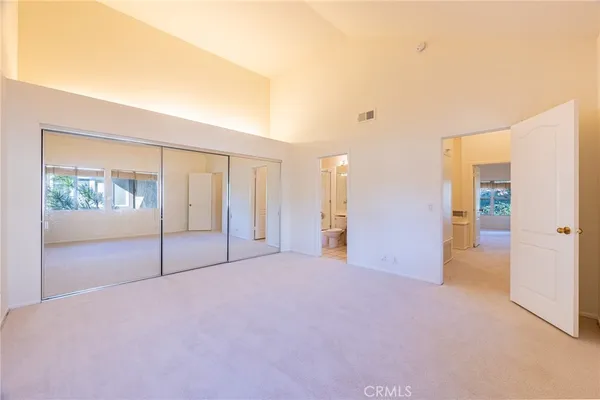a kitchen with a sink a stove cabinets and a dining table