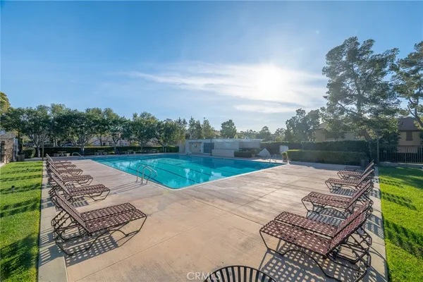 an aerial view of a house with swimming pool and patio