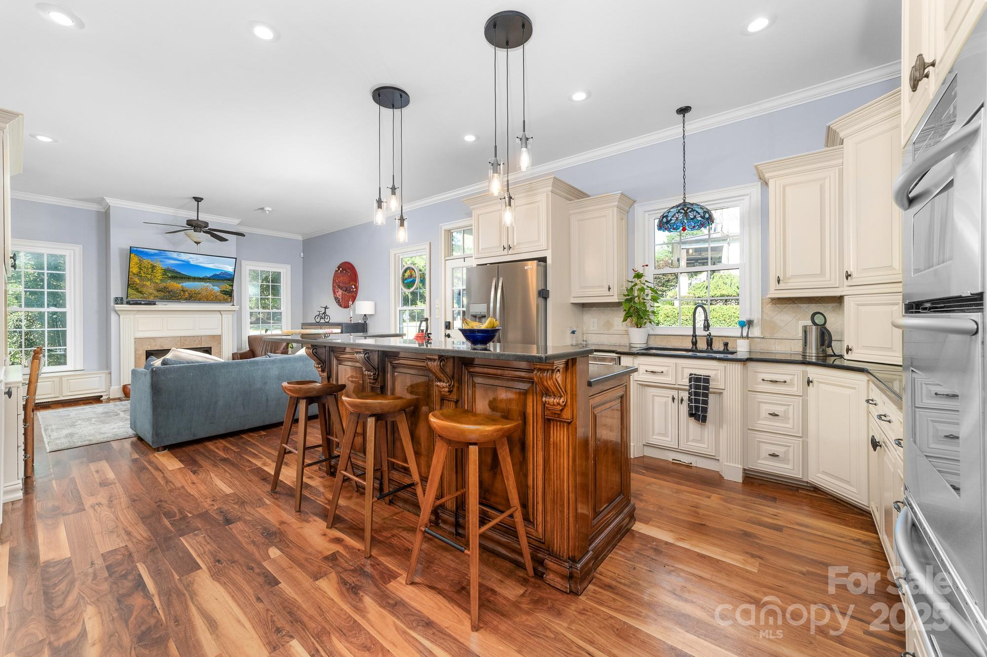 200 Galey Ridge Cramerton, NC 28032 - Photo 11 of 48 a open kitchen with stainless steel appliances granite countertop a stove a sink a microwave a center island and furniture
