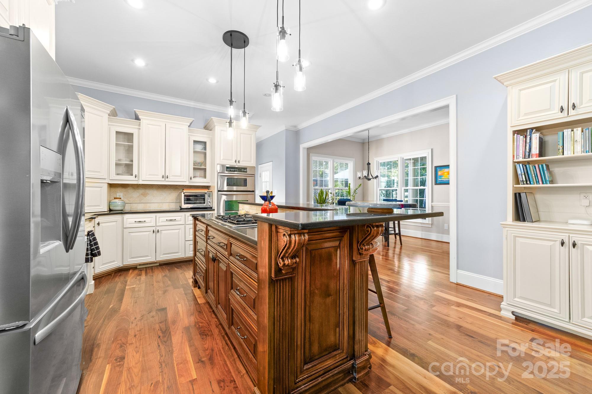 200 Galey Ridge Cramerton, NC 28032 - Photo 14 of 48 a kitchen with stainless steel appliances granite countertop a refrigerator a sink dishwasher a stove and white cabinets with wooden floor