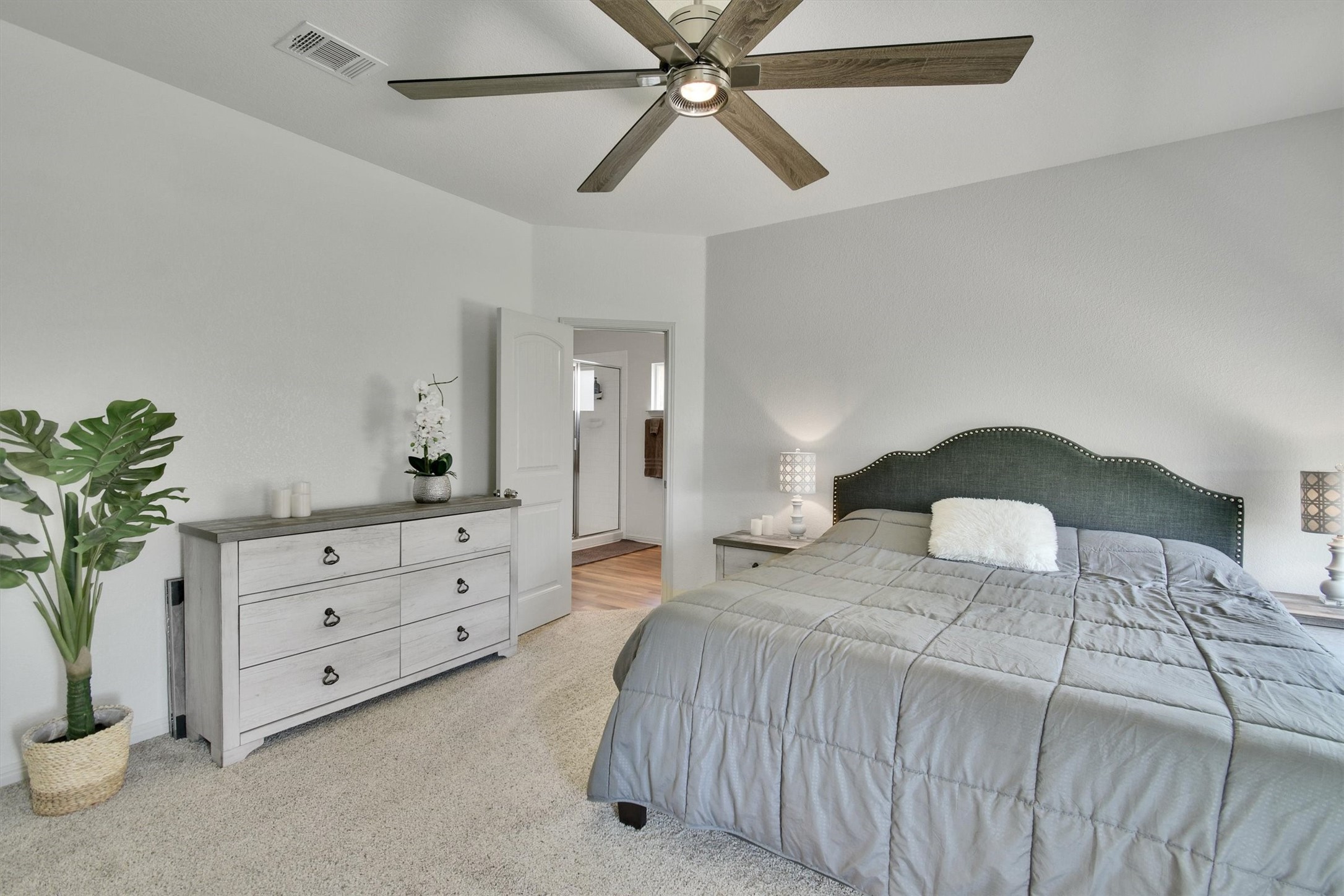 324 Shiner Lane Georgetown, TX 78626 - Photo 18 of 39 a bedroom with a bed and a potted plant