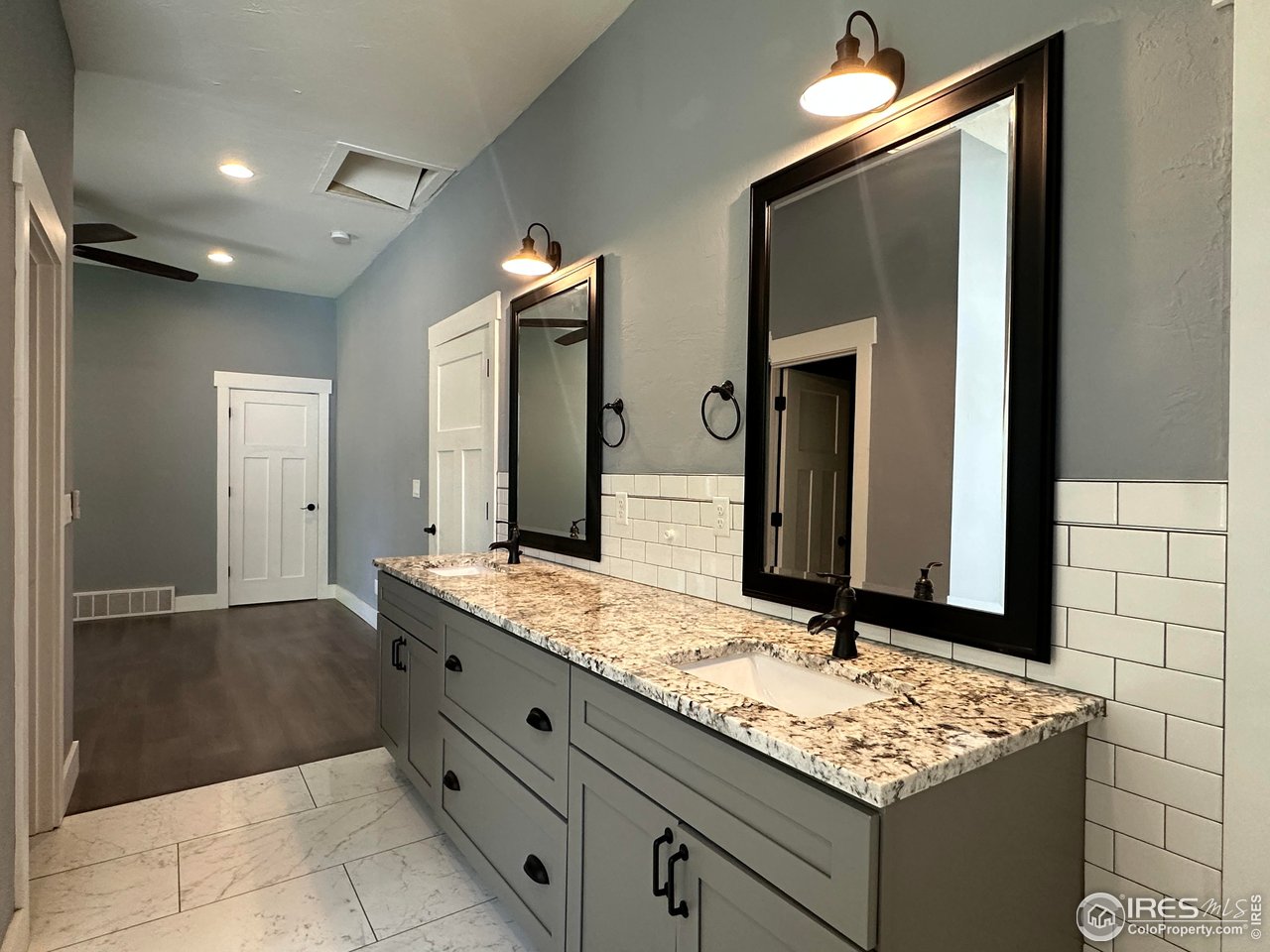 302 Beattie Street Sterling, CO 80751 - Photo 16 of 30 a bathroom with a sink and a mirror