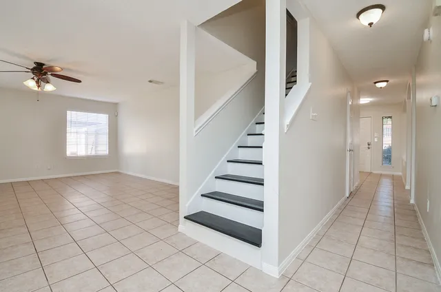 an empty room with a empty space and a ceiling fan