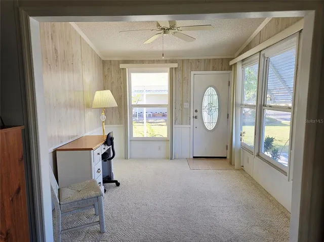 a view of a livingroom with furniture window and a fireplace