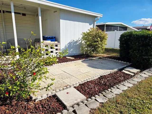 a view of a house with backyard and sitting area