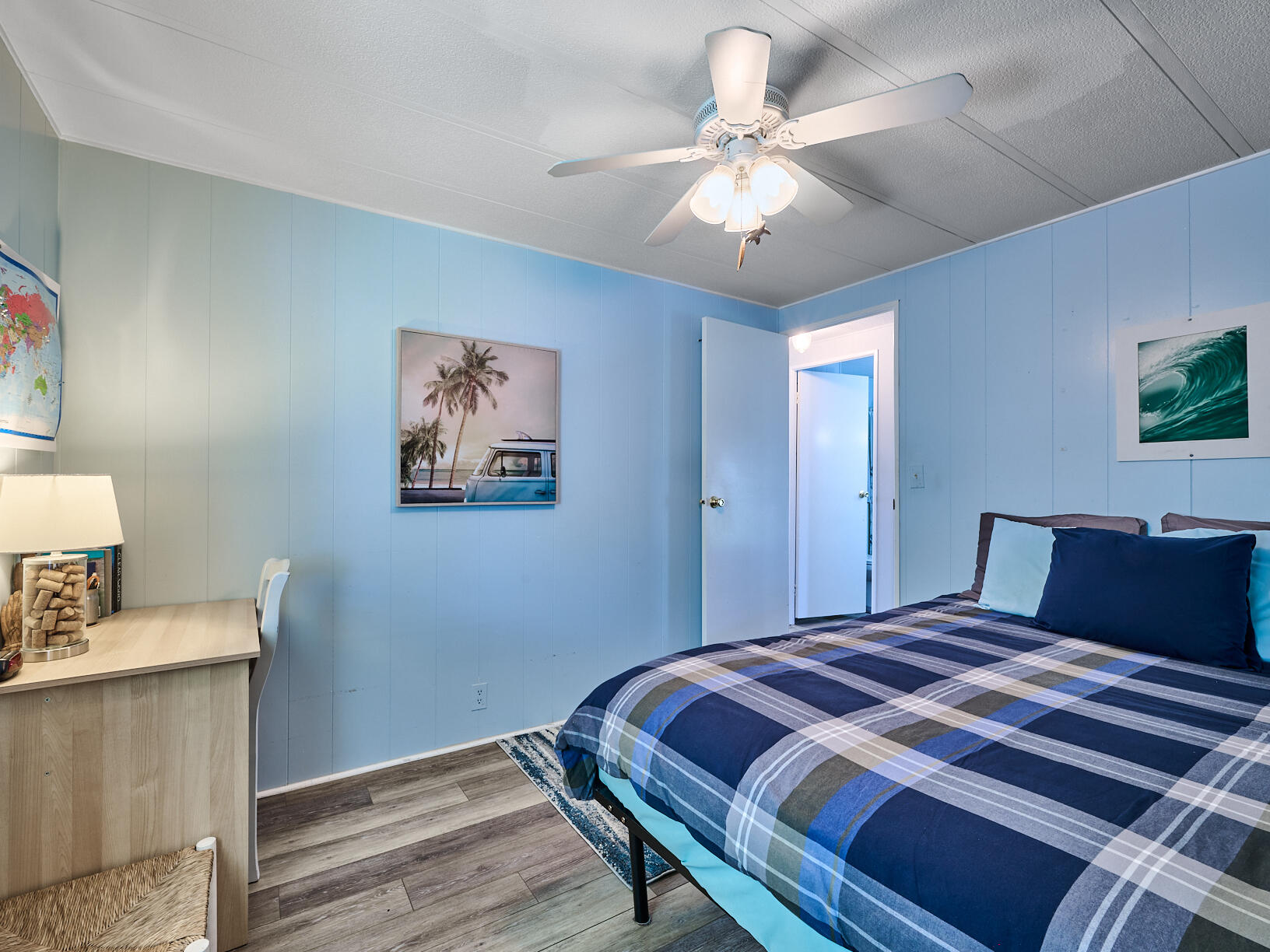 6977 Southeast Delegate Street Hobe Sound, FL 33455 - Photo 37 of 60 a bedroom with a large bed and a chandelier