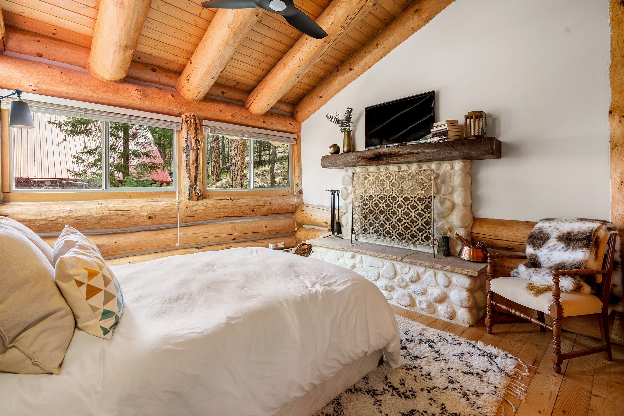 35 Tres Lagunas Road Tererro, NM 87573 - Photo 8 of 32 Main floor Bedroom towards fireplace