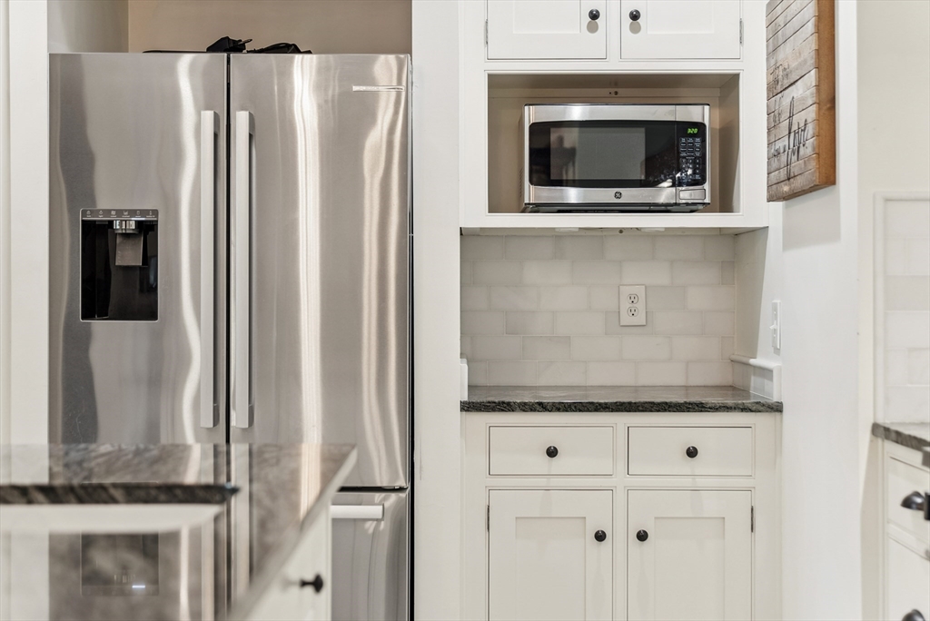 108 Berwick Road Longmeadow, MA 01106 - Photo 6 of 42 a kitchen with granite countertop white cabinets and refrigerator