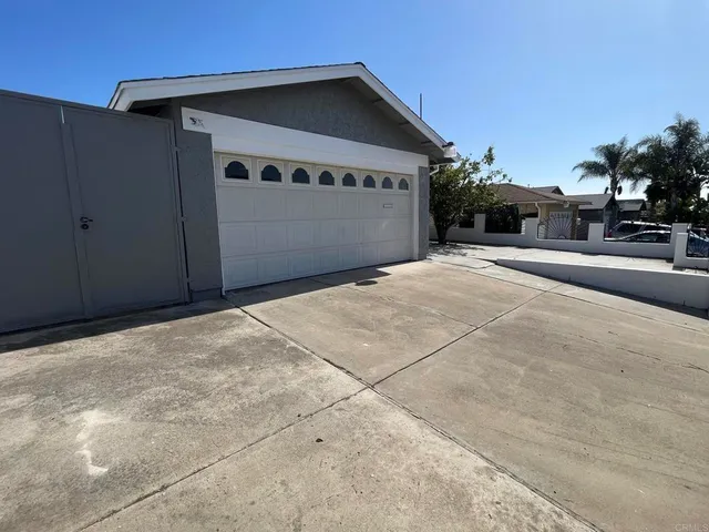 a view of yellow house with tree in front of it