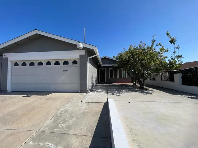 an empty room with closet and windows