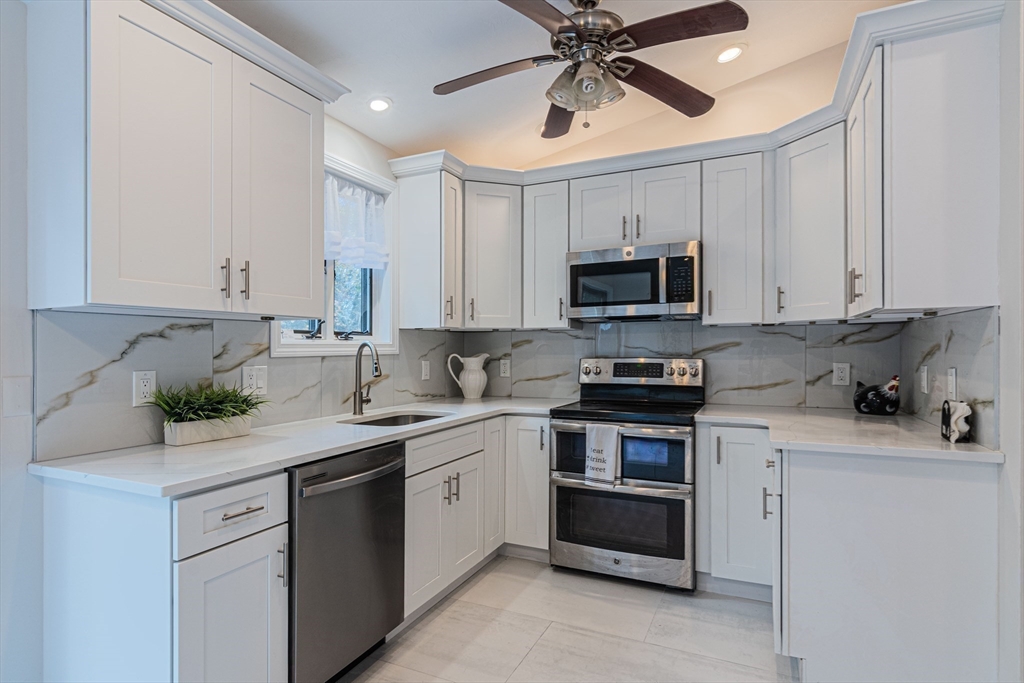 57 Town Farm Road Brookfield, MA 01506 - Photo 16 of 38 a kitchen with a white cabinets and a stove top oven
