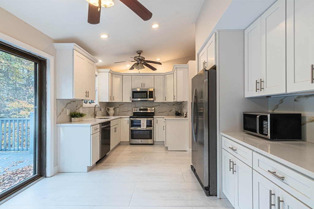 57 Town Farm Road Brookfield, MA 01506 - Photo 18 of 38 a kitchen with white cabinets and stainless steel appliances
