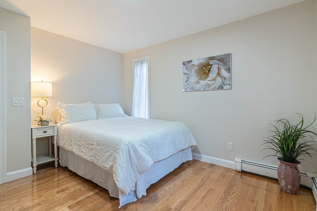 57 Town Farm Road Brookfield, MA 01506 - Photo 25 of 38 a bedroom with a bed and a potted plant