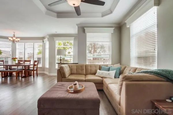 a kitchen with a dining table chairs cabinets wooden floor and appliances