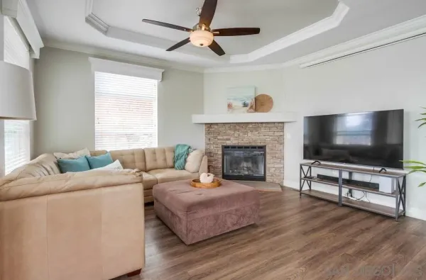 a living room with furniture wooden floor and a large window