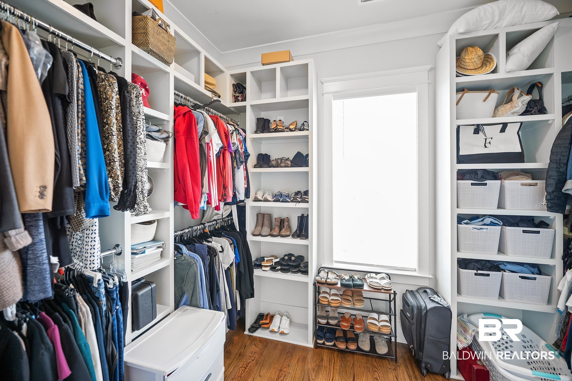 33186 Marlin Key Drive Orange Beach, AL 36561 - Photo 55 of 87 Walk in closet featuring dark wood-type flooring