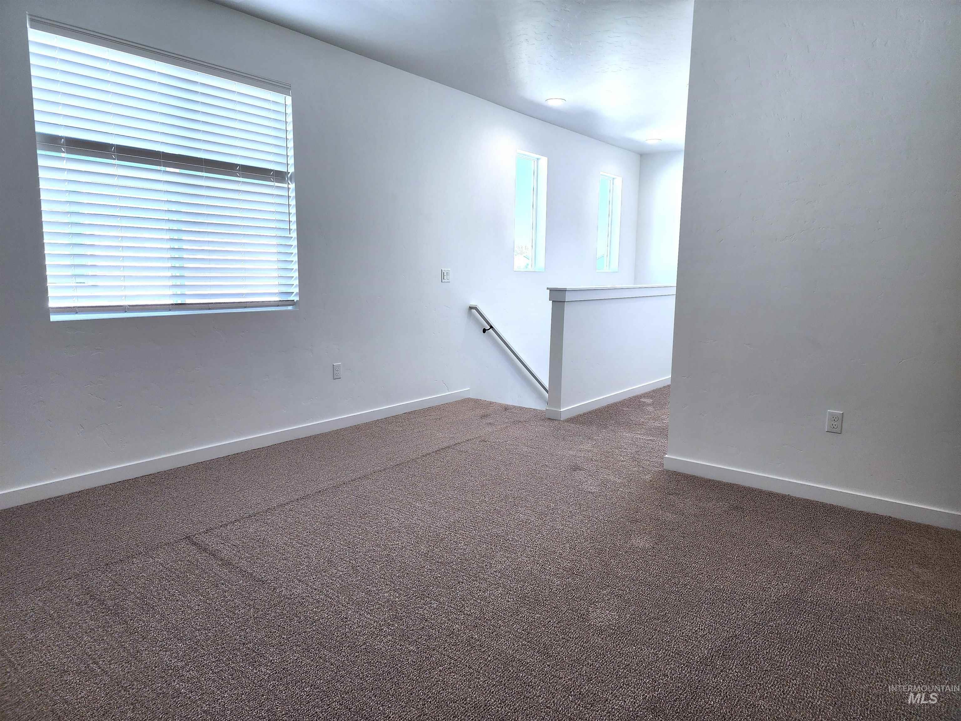 362 North Lagrasse Lane Star, ID 83669 - Photo 10 of 16 Empty room with dark carpet and baseboards