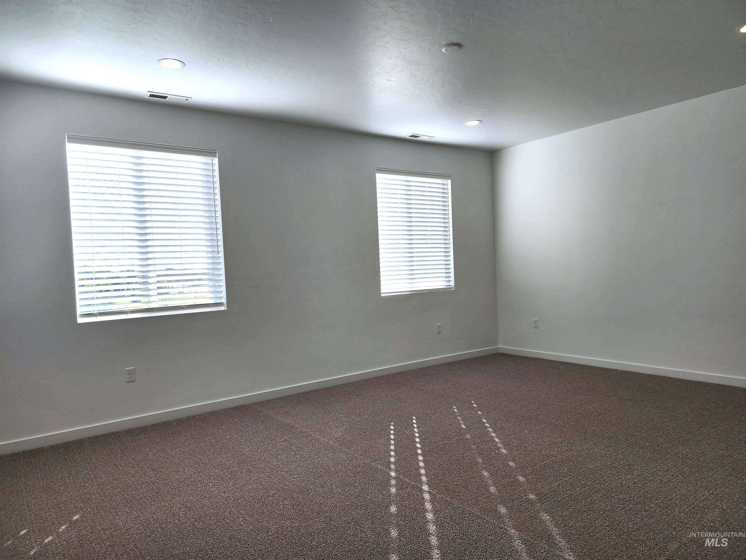 362 North Lagrasse Lane Star, ID 83669 - Photo 6 of 16 Unfurnished room featuring dark carpet and recessed lighting