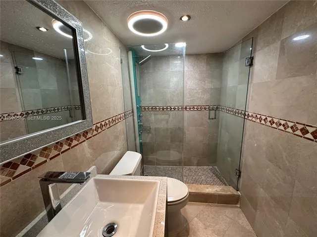 a bathroom with a shower and a toilet