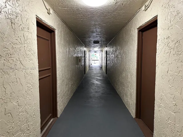 a view of backyard with swimming pool and furniture