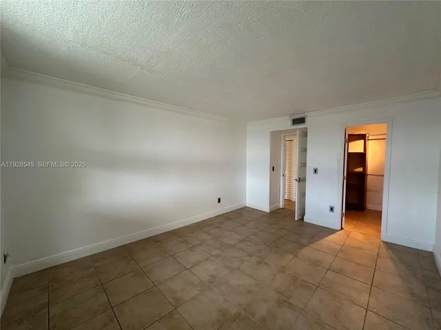 a view of an empty room and a window