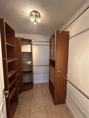 a kitchen with a refrigerator and cabinets