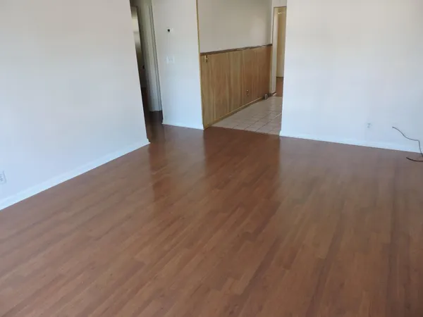 an empty room with wooden floor