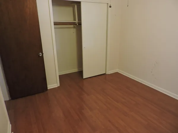 an empty room with wooden floor