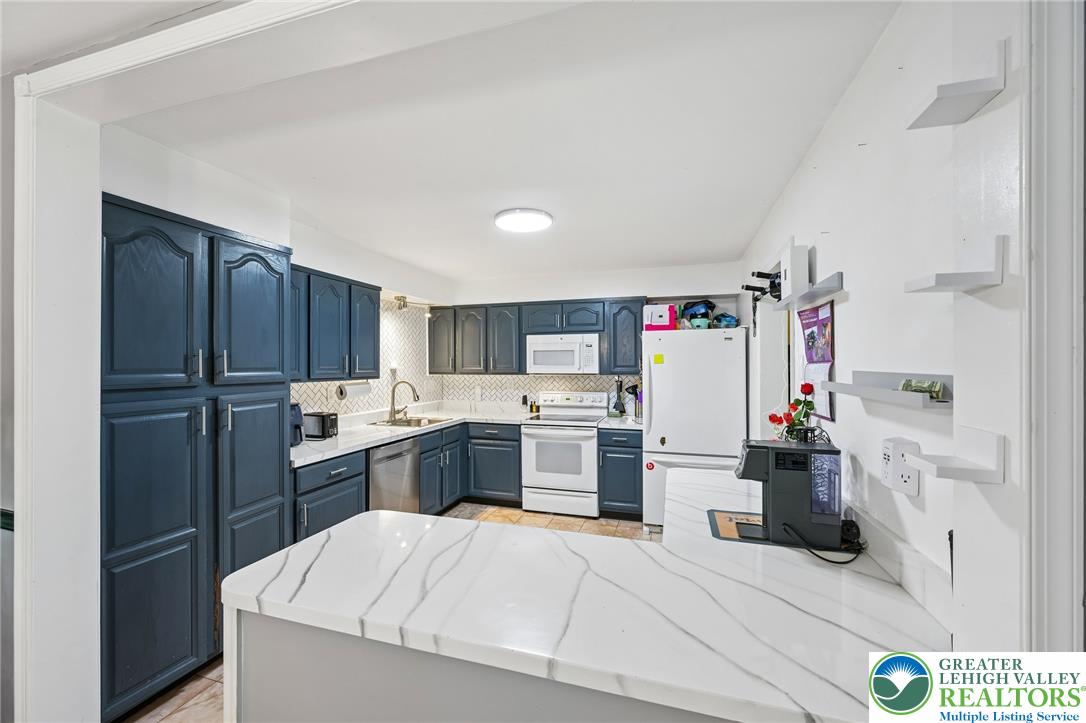 2649 Nottingham Road Bethlehem, PA 18017 - Photo 11 of 49 Bright, open-concept kitchen features sleek blue cabinetry and ample counter space.