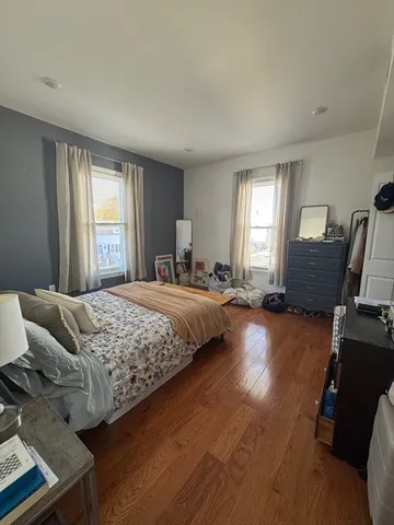 a bedroom with bed and window