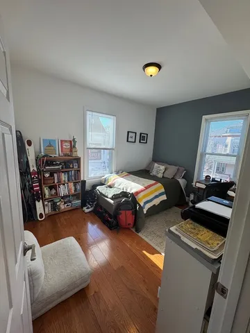 a bedroom with furniture and a book shelf