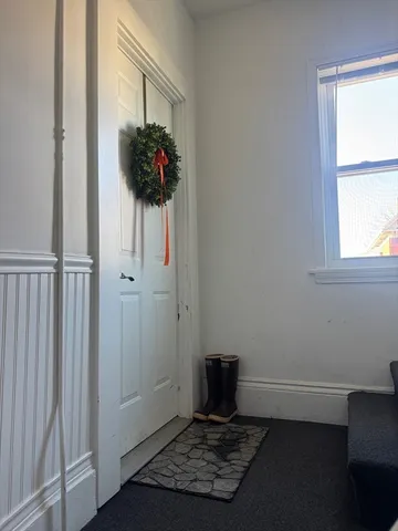 a room with window and a potted plant