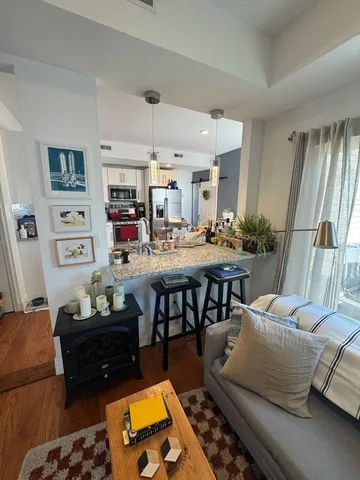 a living room with furniture and a dining table