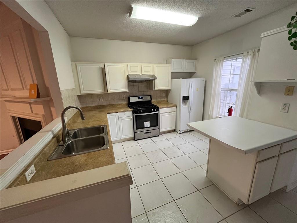 5764 Reps Trace Norcross, GA 30071 - Photo 16 of 25 a kitchen with kitchen island a sink a stove and a refrigerator