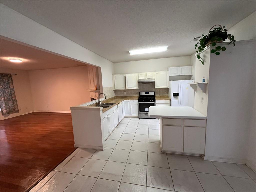 5764 Reps Trace Norcross, GA 30071 - Photo 17 of 25 a large white kitchen with cabinets