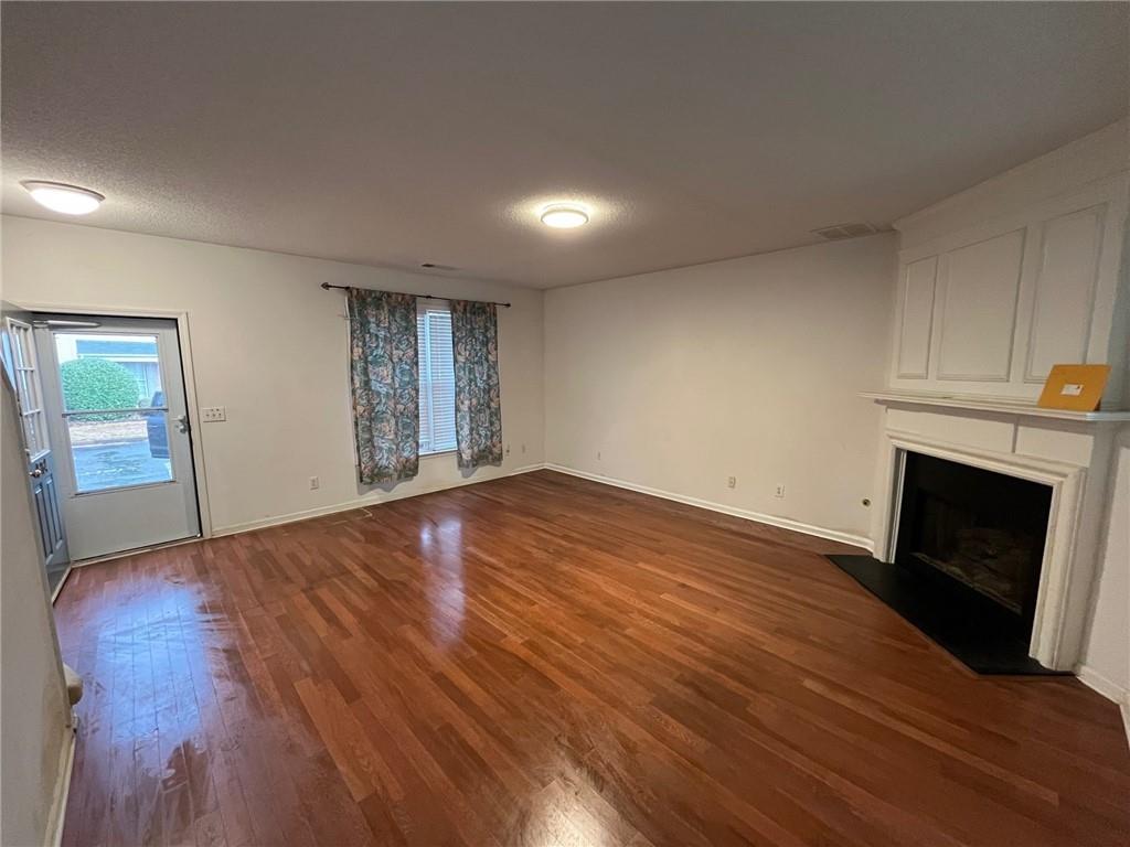 5764 Reps Trace Norcross, GA 30071 - Photo 10 of 25 a view of empty room with wooden floor and fireplace