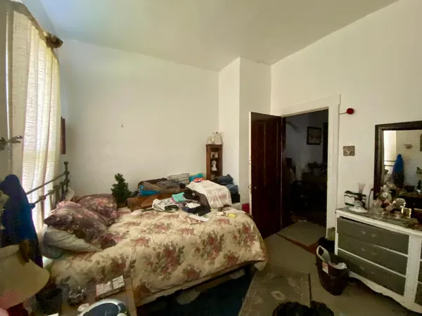 a bed room with a bed and a window