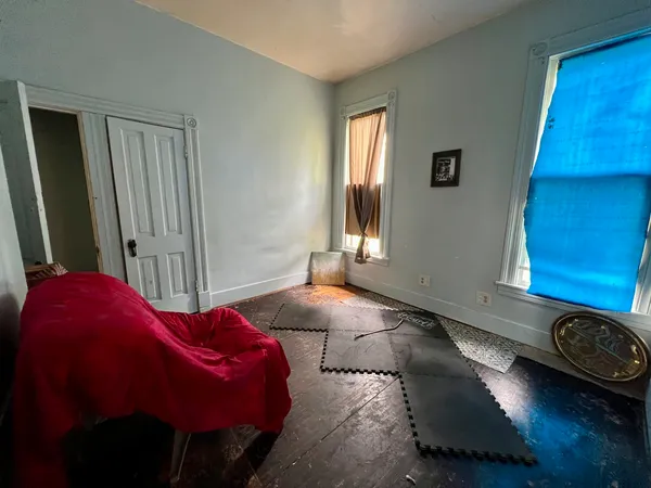 a view of a livingroom with furniture and a window