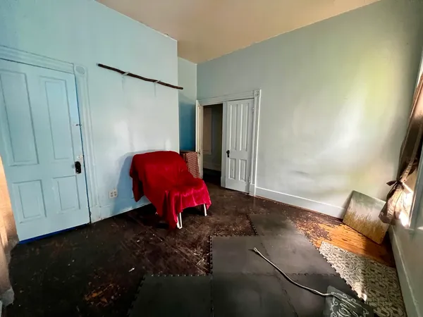 a view of a room with wooden floor and furniture