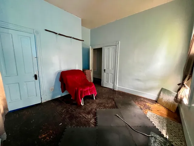 a view of a room with wooden floor and furniture