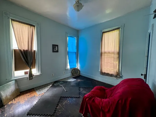 a view of an empty room with a fireplace