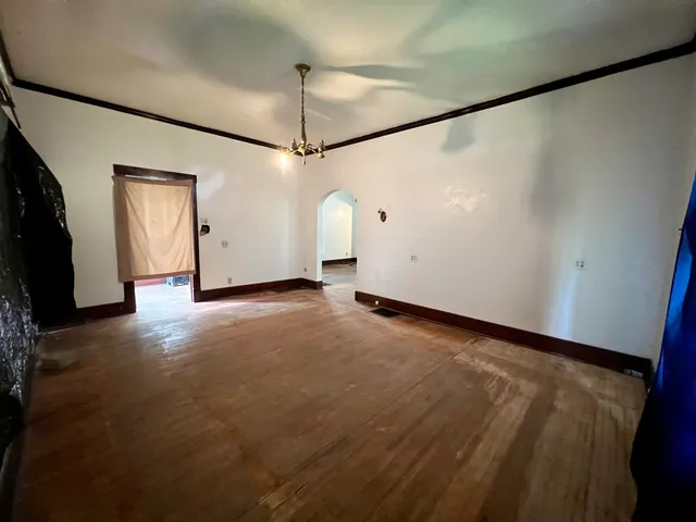 a view of an empty room with a window and a fireplace