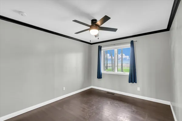 a view of an empty room with a ceiling fan