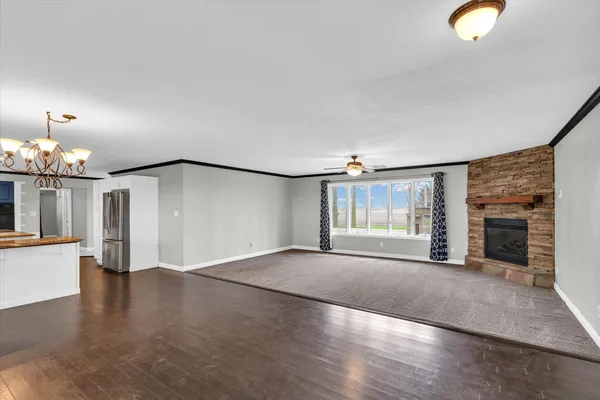 a view of a livingroom with furniture wooden floor and chandelier