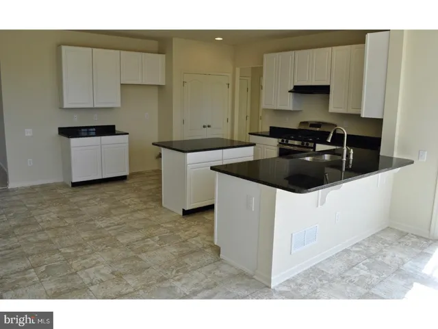 a kitchen with a stove a sink and a microwave