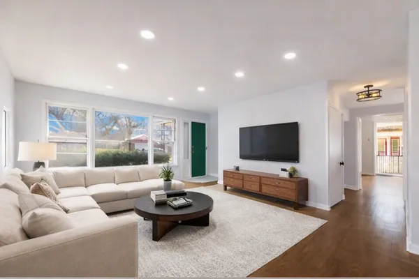 a living room with furniture and a flat screen tv