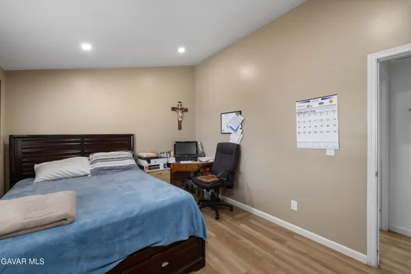 a bedroom with a bed and a desk