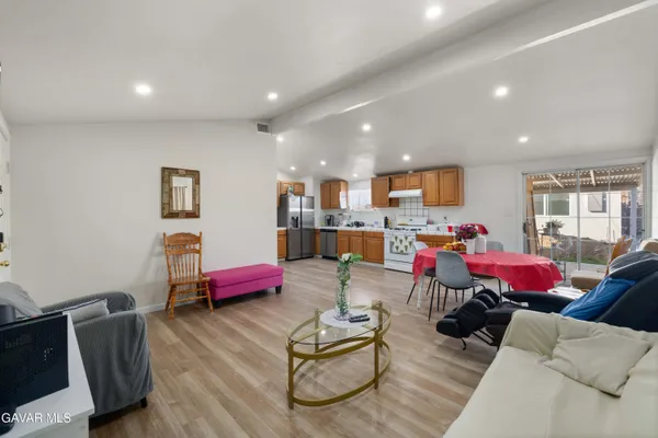 a living room with furniture and kitchen view