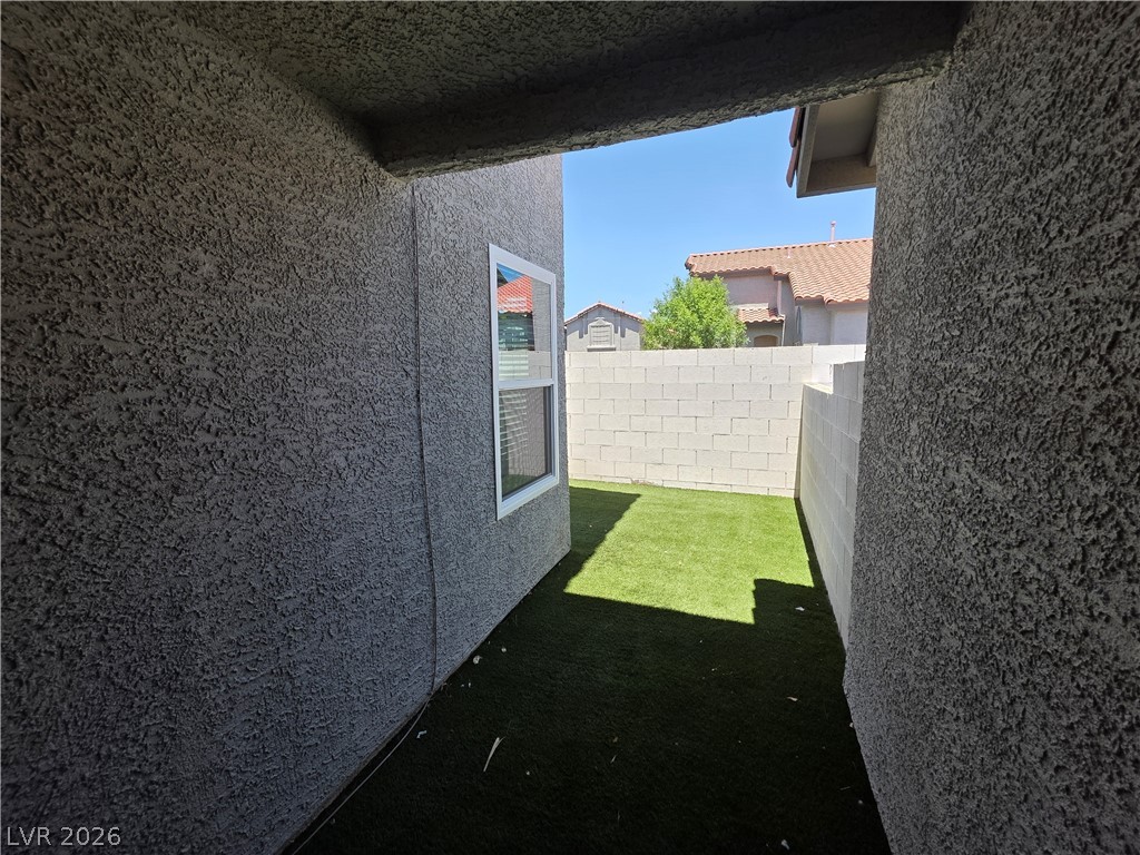 2275 Ramsgate Drive Henderson, NV 89074 - Photo 15 of 84 A compact yard offers artificial turf and sturdy block fencing for private outdoor living.
