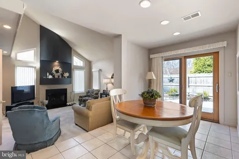 a living room with fireplace furniture and a fireplace